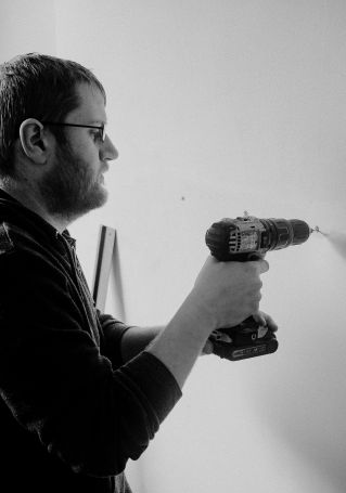 Man Drilling Wall in House